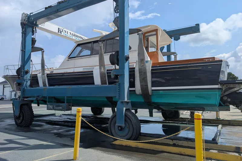 Slide: The Image of 1998 Little Harbor WhisperJet 55 boat named "Good Ship" on a lift at a marina. - 47