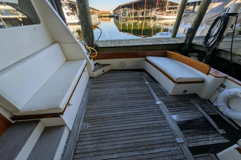 Slide: The Image of Cockpit of 1998 Little Harbor WhisperJet 55 with wooden deck and white seating. - 5