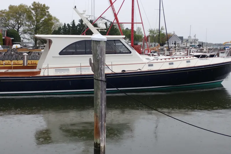 Slide: The Image of 1998 Little Harbor WhisperJet 55 yacht docked in a marina on a rainy day. - 51