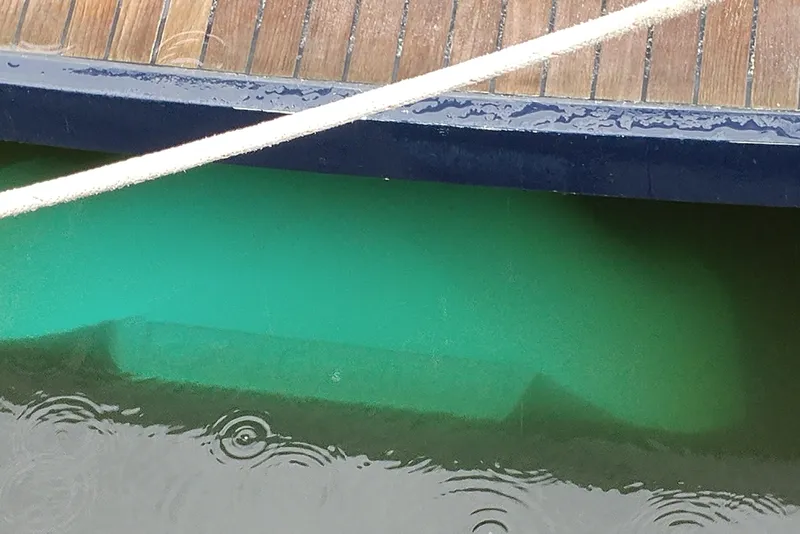 Slide: The Image of Underwater view of a 1998 Little Harbor WhisperJet 55 hull near a wooden dock. - 52