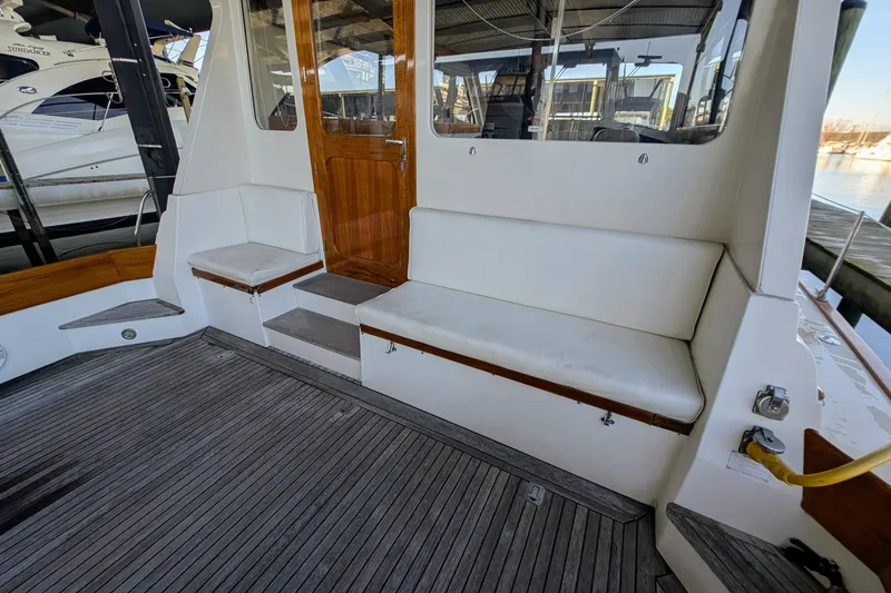 Slide: The Image of 1998 Little Harbor WhisperJet 55 yacht deck with seating and wooden door. - 6