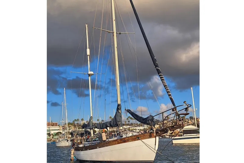 Slide: The Image of 1977 Hans Christian 38 sailboat docked under cloudy sky. - 3