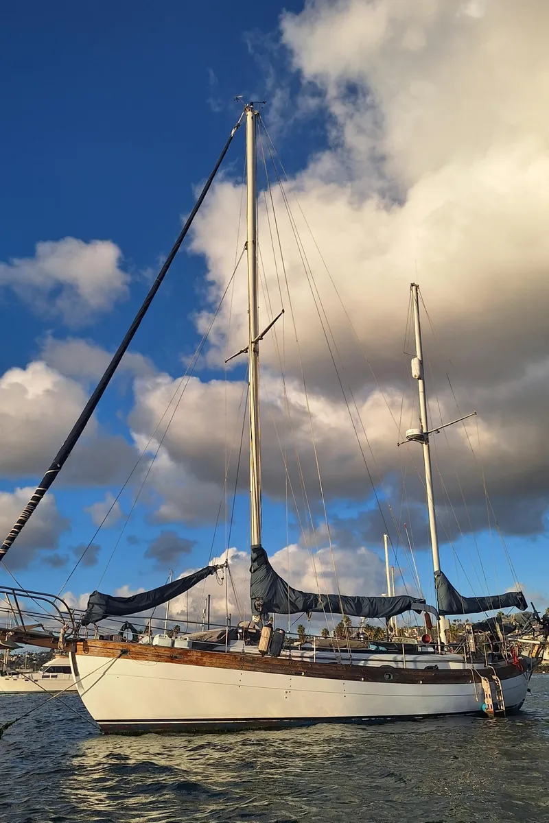 Slide: The Image of 1977 Hans Christian 38 sailboat on water under cloudy sky. - 4