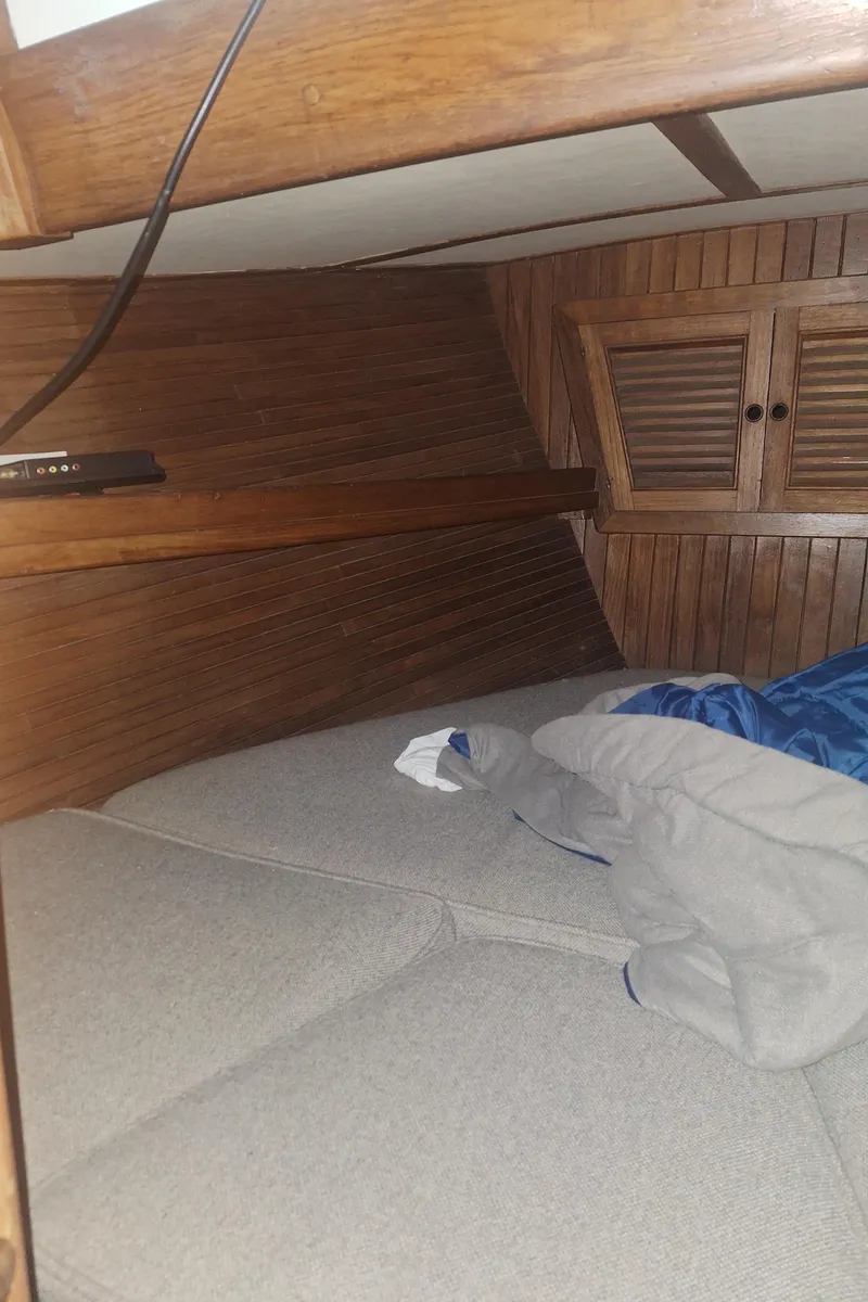Slide: The Image of Cozy cabin interior of 1977 Hans Christian 38 sailboat with wooden paneling and bedding. - 8
