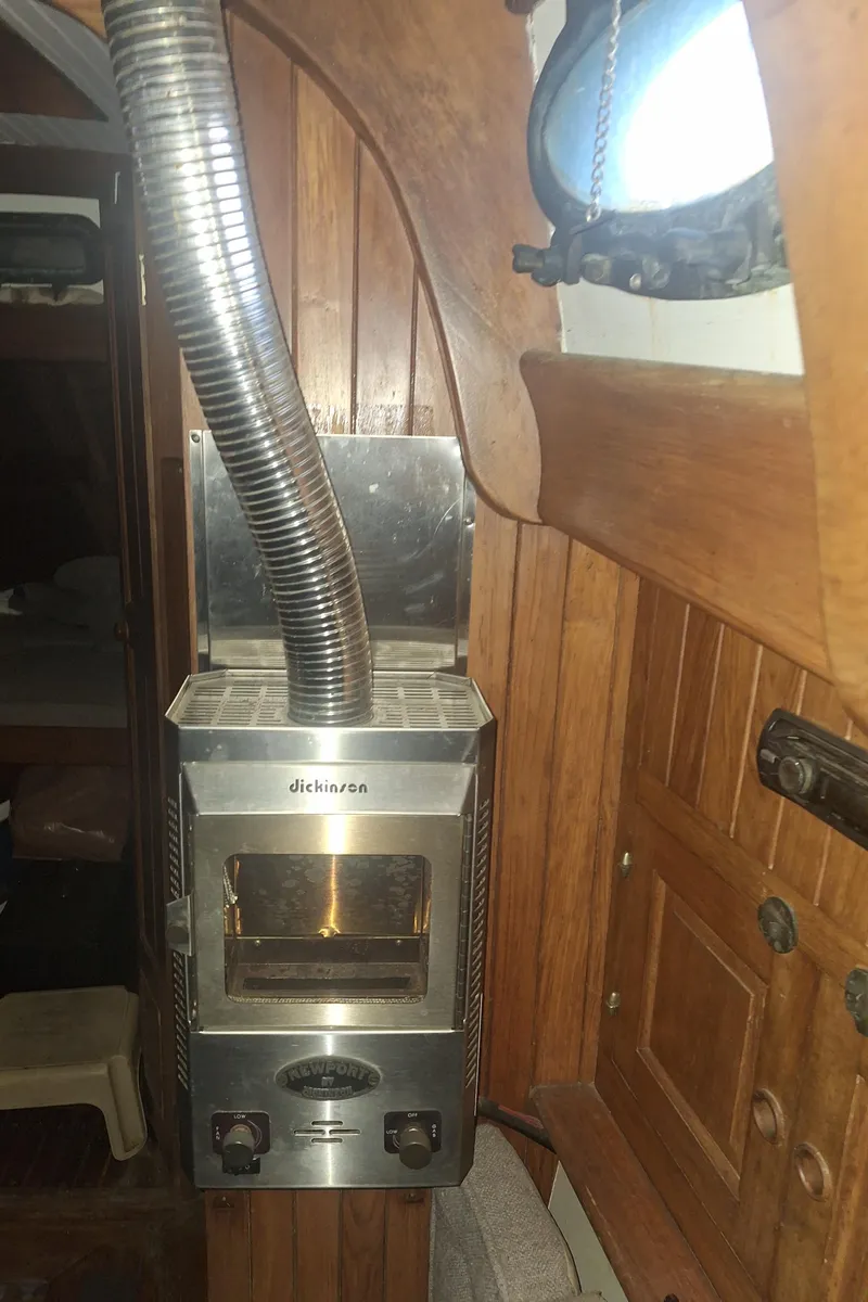 Slide: The Image of Wood-paneled interior of 1977 Hans Christian 38 with a stainless steel stove. - 9