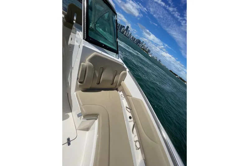 Slide: The Image of 2016 Pursuit DC 325 Dual Console boat interior with city skyline and ocean view. - 12