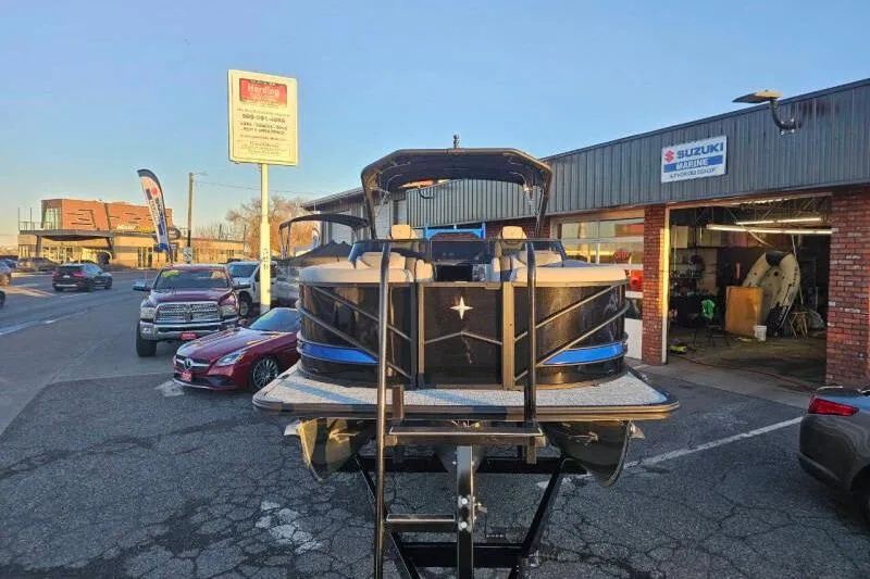 Slide: The Image of 2026 Berkshire 25RFX DC STS SPORT ARCH boat displayed outside a dealership. - 10