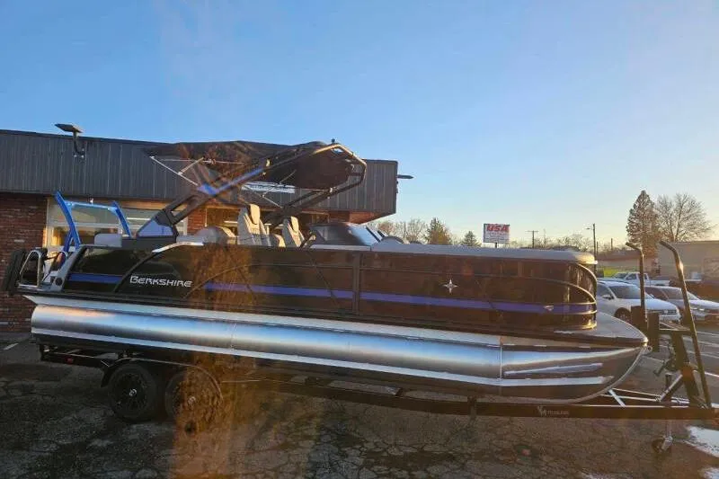 Slide: The Image of 2026 Berkshire 25RFX DC STS SPORT ARCH pontoon boat on trailer, parked outdoors. - 11