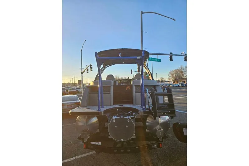 Slide: The Image of 2026 Berkshire 25RFX DC STS SPORT ARCH boat at a street intersection during sunset. - 12