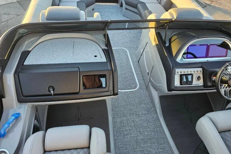 Slide: The Image of 2026 Berkshire 25RFX DC STS SPORT ARCH boat interior with modern dashboard and seating. - 18