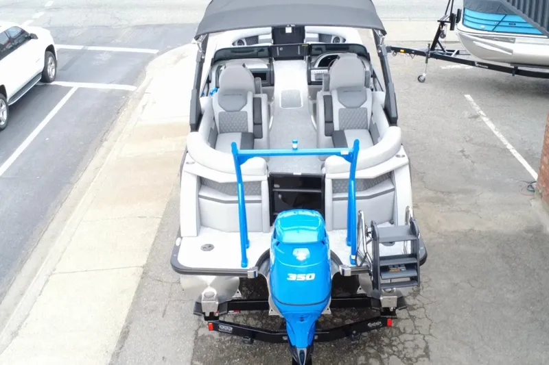 Slide: The Image of 2026 Berkshire 25RFX DC STS SPORT ARCH boat with blue motor, parked on a trailer. - 4