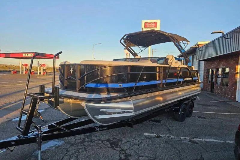 Slide: The Image of 2026 Berkshire 25RFX DC STS SPORT ARCH pontoon boat on trailer at a Texaco station. - 6