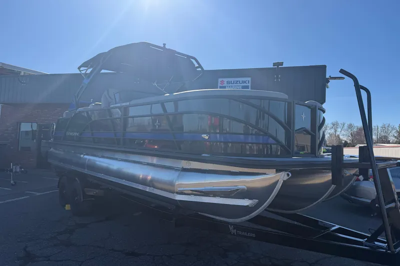 Slide: The Image of 2026 Berkshire 25RFX DC STS SPORT ARCH pontoon boat on trailer, parked outside dealership. - 8