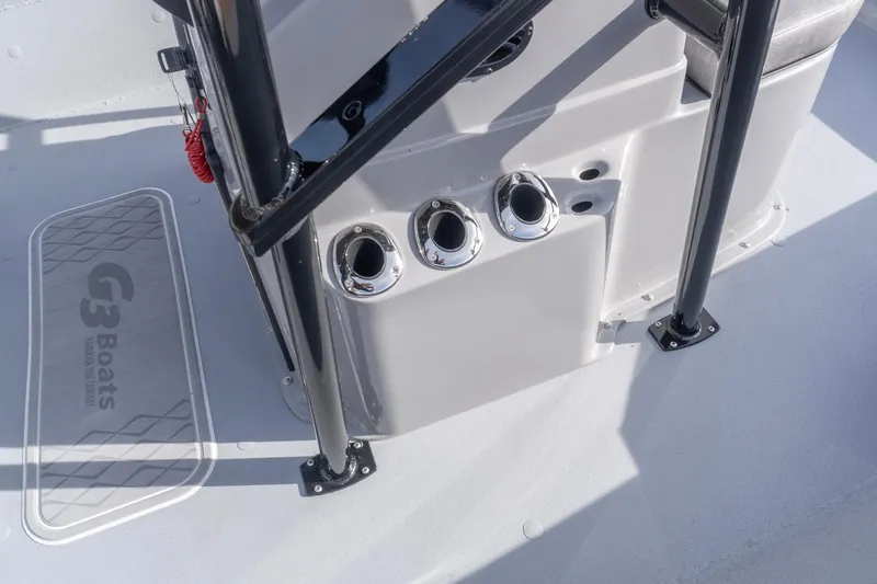 Slide: The Image of 2026 G3 Bay 21 GX boat deck with rod holders and branding. - 11