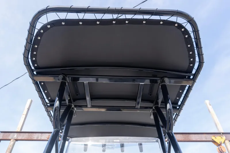 Slide: The Image of T-top view of 2026 G3 Bay 21 GX boat against blue sky. - 13