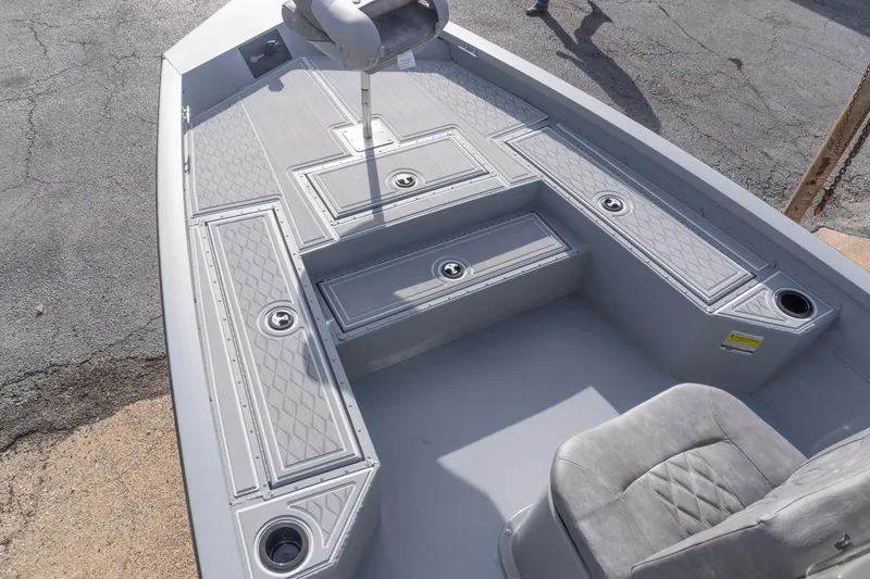 Slide: The Image of 2026 G3 Bay 21 GX boat interior with gray seating and storage compartments. - 14