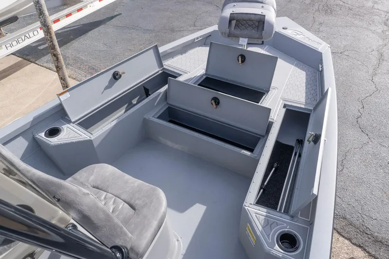 Slide: The Image of 2026 G3 Bay 21 GX boat interior with open storage compartments and seating. - 15