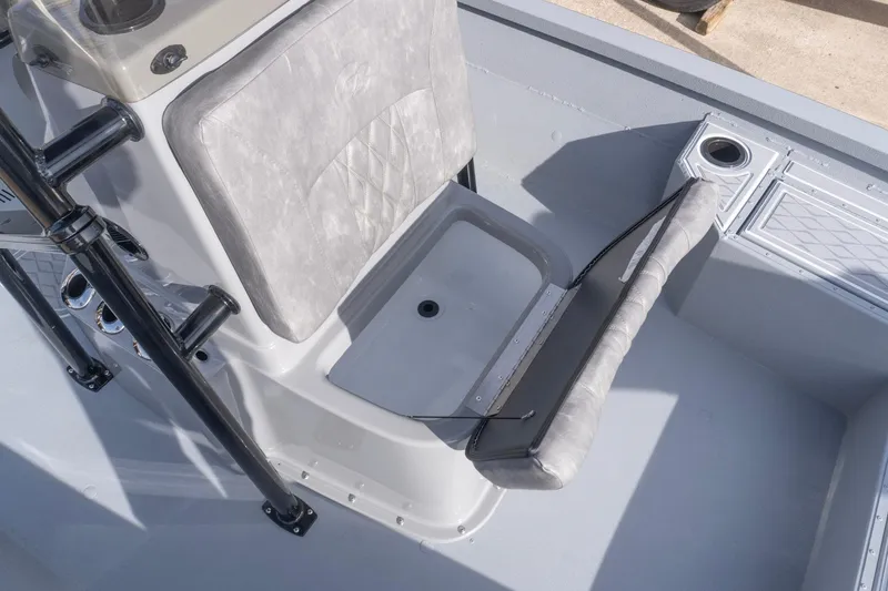 Slide: The Image of 2026 G3 Bay 21 GX boat interior with cushioned seating and storage compartment. - 17