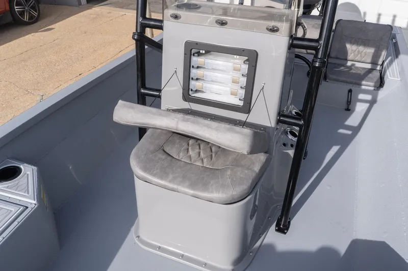 Slide: The Image of 2026 G3 Bay 21 GX boat interior with cushioned seating and console. - 18