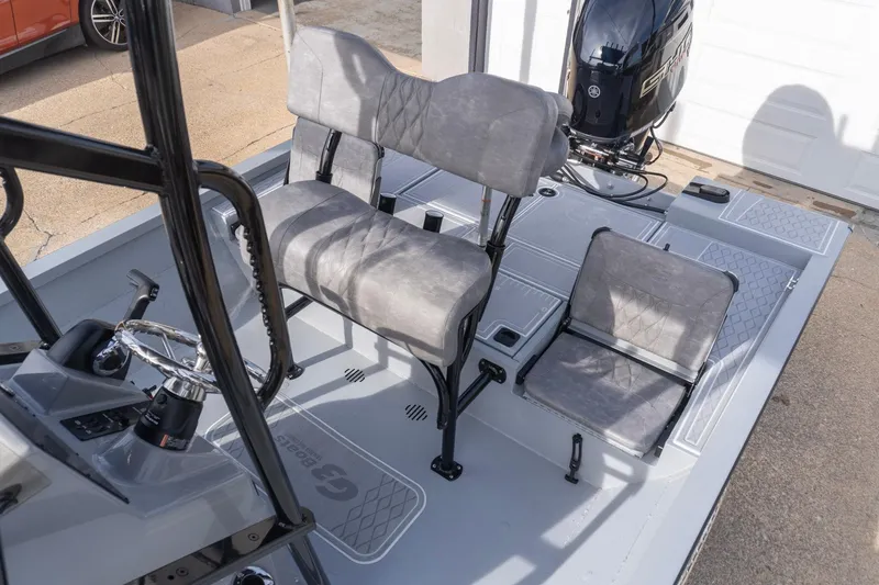 Slide: The Image of 2026 G3 Bay 21 GX boat interior with seating and steering console. - 19