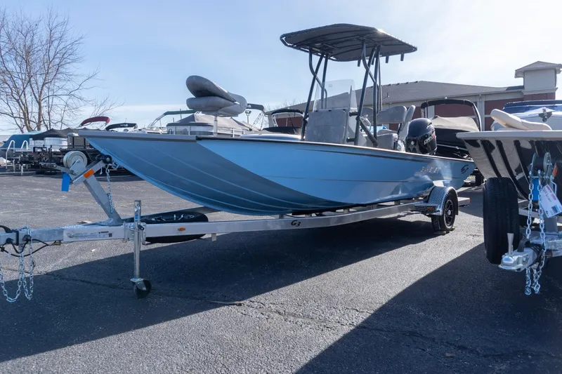 Slide: The Image of 2026 G3 Bay 21 GX boat on trailer in outdoor showroom. - 2