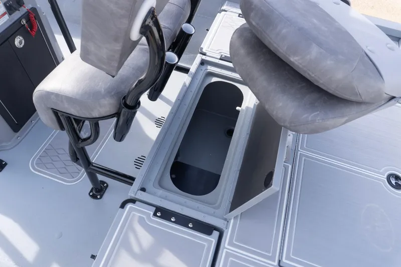 Slide: The Image of 2026 G3 Bay 21 GX boat interior with open storage compartment and cushioned seats. - 20