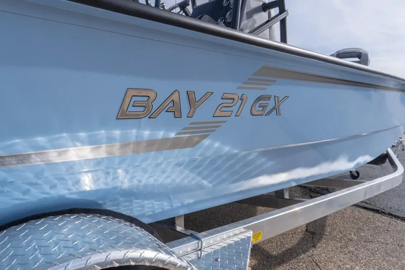 Slide: The Image of 2026 G3 Bay 21 GX boat on trailer, showcasing sleek design and branding. - 4