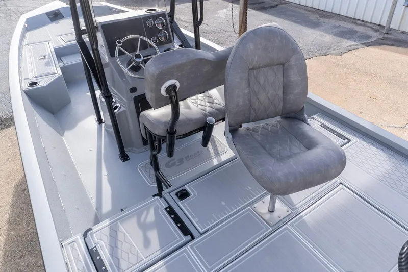 Slide: The Image of 2026 G3 Bay 21 GX boat interior with gray seating and steering console. - 5