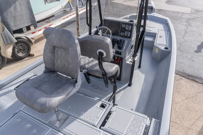 Slide: The Image of 2026 G3 Bay 21 GX boat interior with gray seating and control panel. - 6