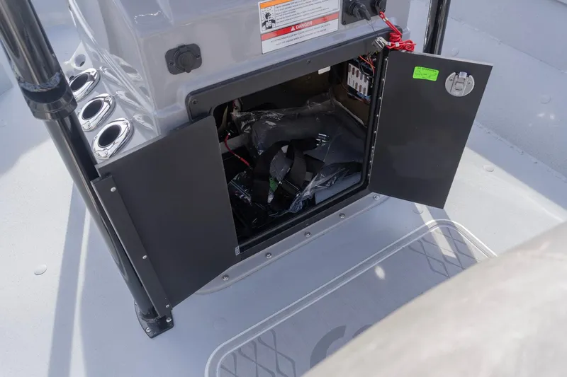 Slide: The Image of Open storage compartment on 2026 G3 Bay 21 GX boat, showing interior equipment and wiring. - 9