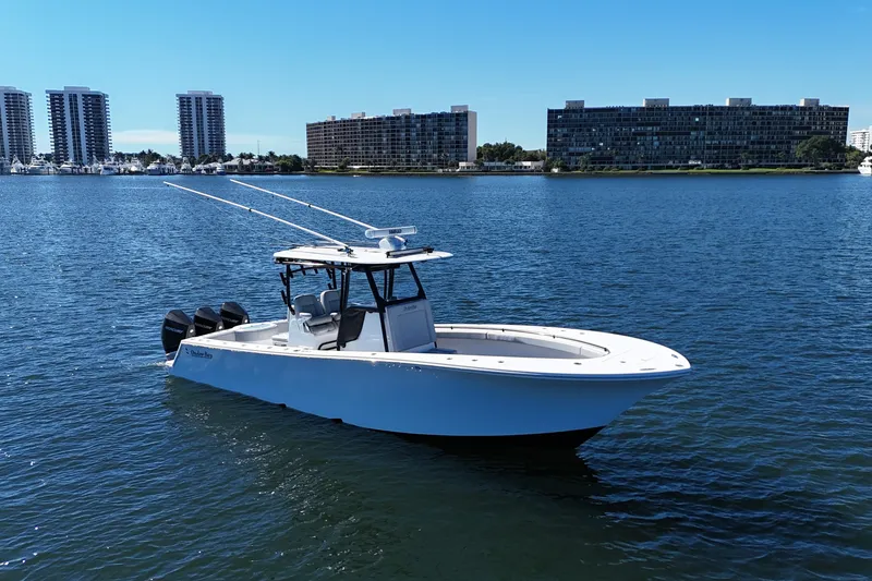 The Image of 2021 Onslow Bay 33 Tournament boat on water with city skyline background. - 1