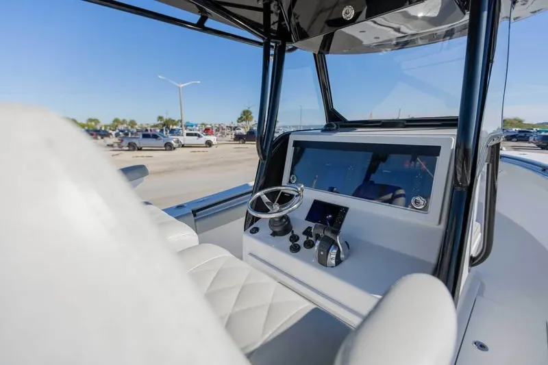 Slide: The Image of 2021 Onslow Bay 33 Tournament boat dashboard with steering wheel and controls. - 13