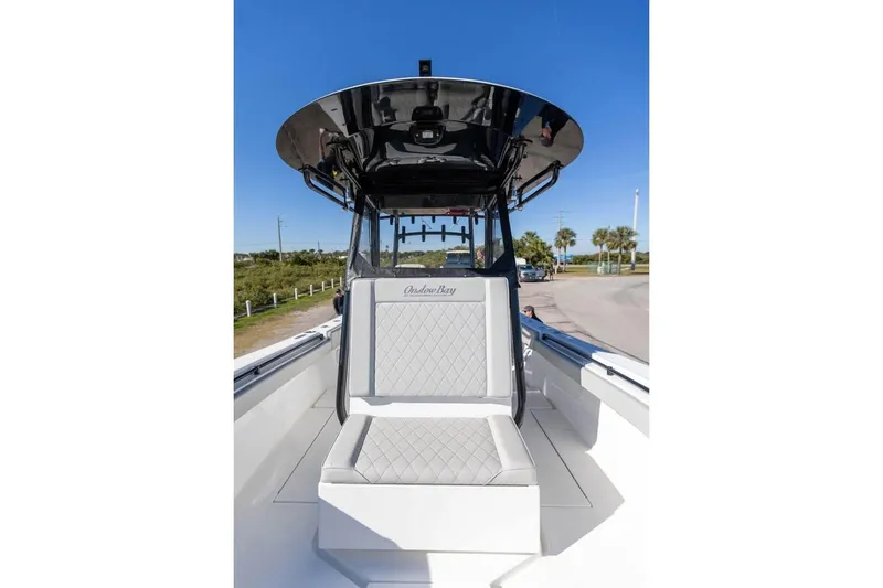 Slide: The Image of 2021 Onslow Bay 33 Tournament boat with cushioned seating and T-top under clear blue sky. - 14