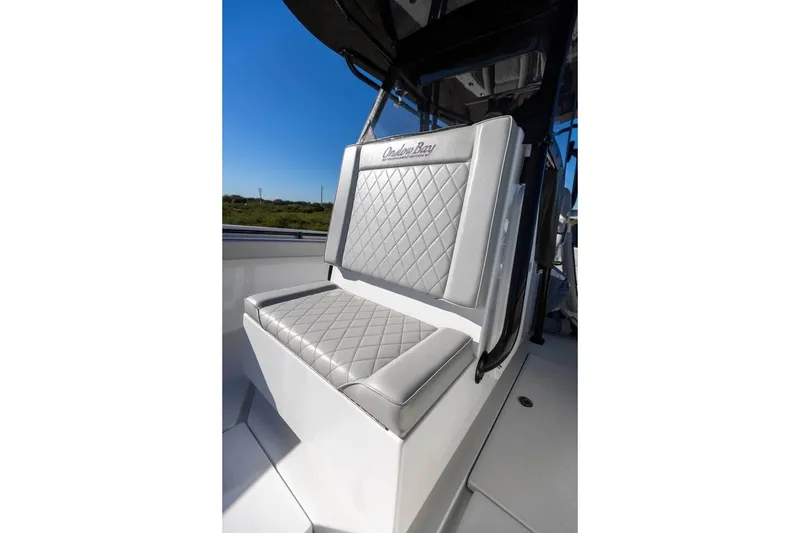 Slide: The Image of 2021 Onslow Bay 33 Tournament boat seat with diamond-stitched upholstery under clear blue sky. - 16