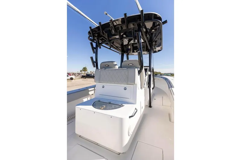 Slide: The Image of 2021 Onslow Bay 33 Tournament boat interior with seating and T-top under clear blue sky. - 17
