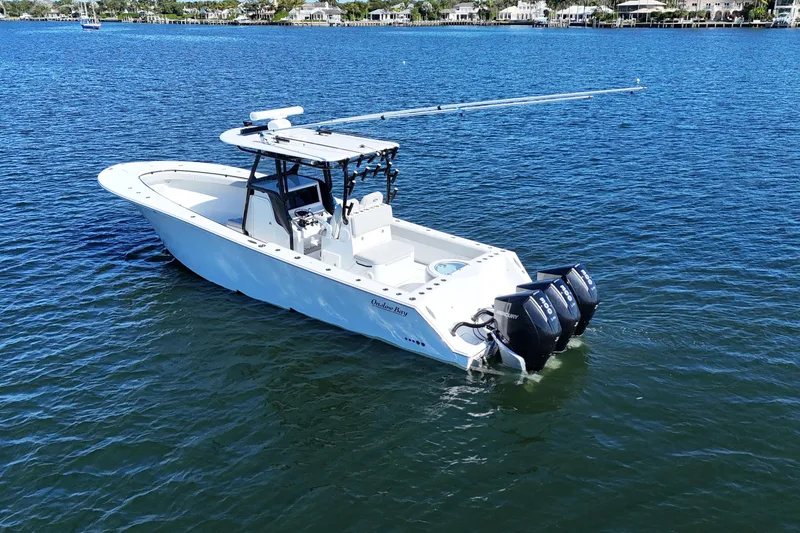 Slide: The Image of 2021 Onslow Bay 33 Tournament boat on calm water with triple outboard engines. - 4