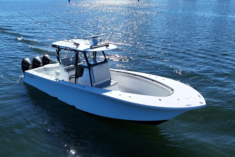 Slide: The Image of 2021 Onslow Bay 33 Tournament boat on calm water, featuring triple outboard engines. - 6