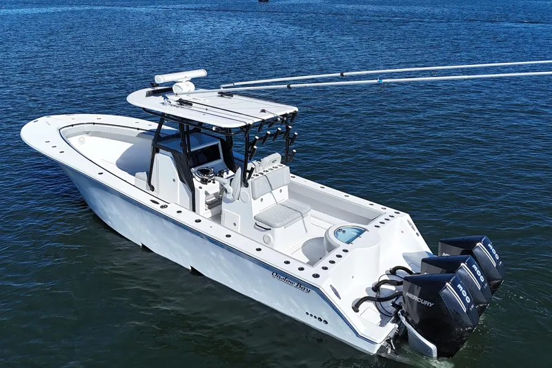 Slide: The Image of 2021 Onslow Bay 33 Tournament boat on water with triple Mercury engines. - 7