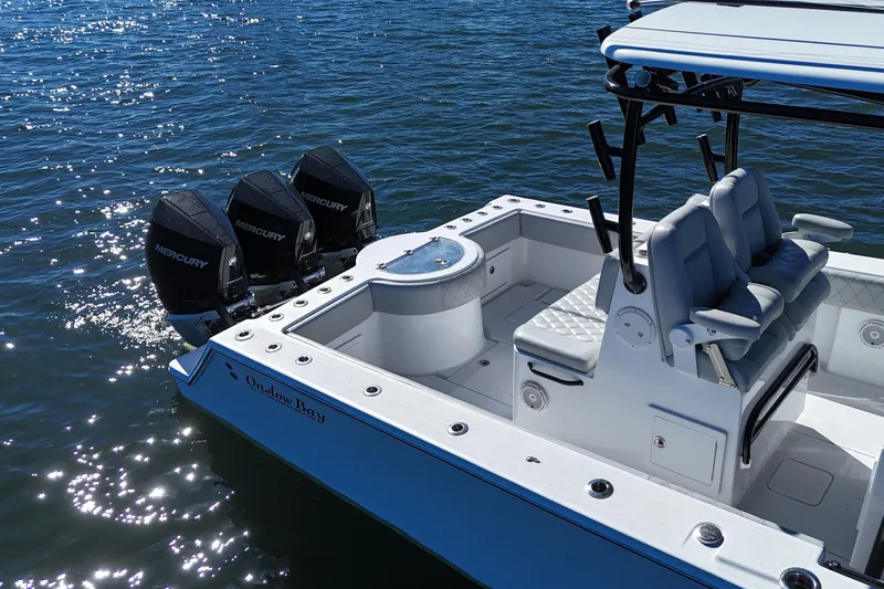 Slide: The Image of 2021 Onslow Bay 33 Tournament boat with triple Mercury engines on the water. - 9