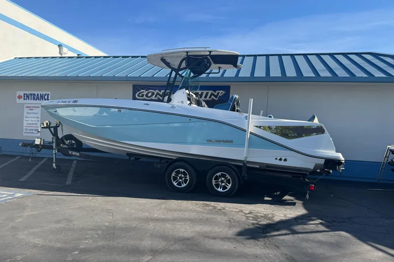 The Image of 2020 Scarab 255 Open ID boat on trailer, parked outside a building. - 1