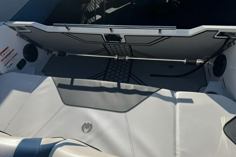Slide: The Image of 2020 Scarab 255 Open ID boat interior with seating and storage compartment. - 12