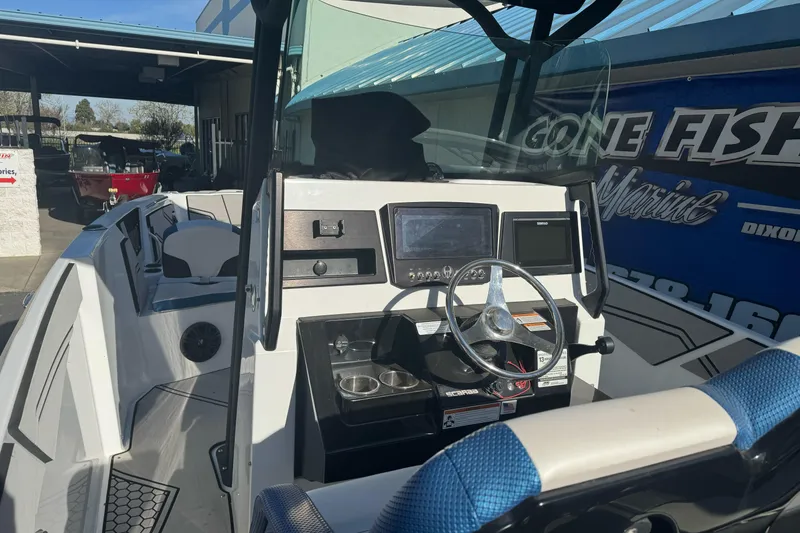 Slide: The Image of 2020 Scarab 255 Open ID boat interior with steering wheel and dashboard controls. - 13