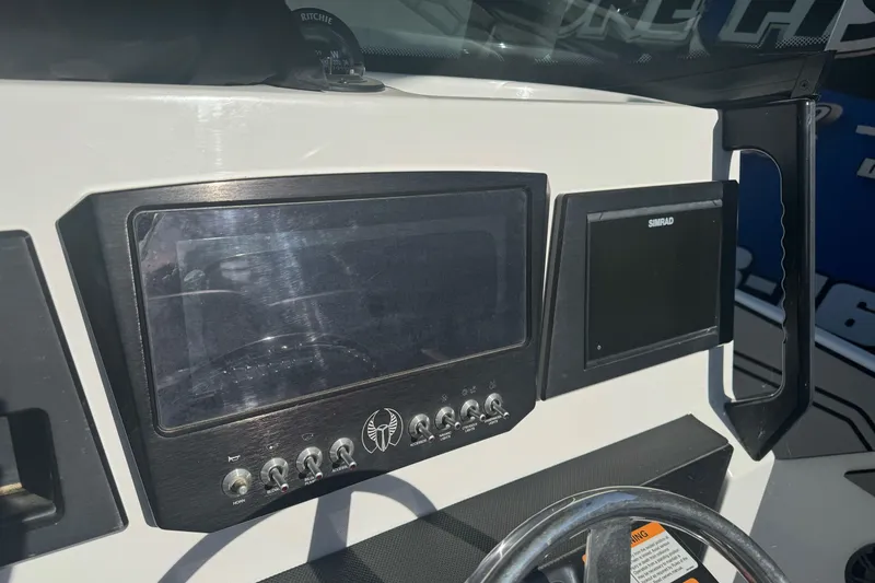 Slide: The Image of Dashboard of 2020 Scarab 255 Open ID boat with navigation screens and controls. - 17
