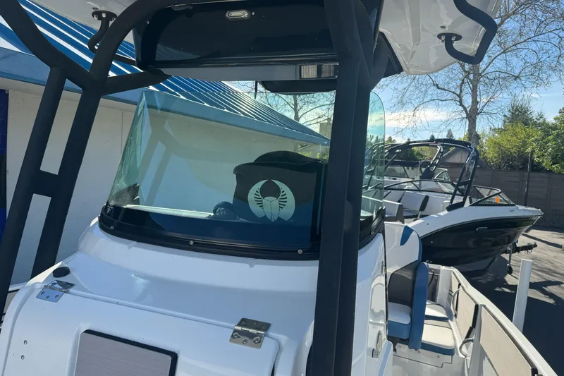 Slide: The Image of 2020 Scarab 255 Open ID boat with sleek design, docked outdoors. - 20