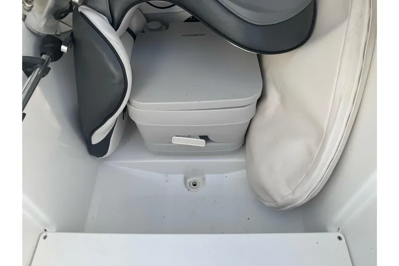 Slide: The Image of 2020 Scarab 255 Open ID boat interior with storage compartment and portable toilet. - 22