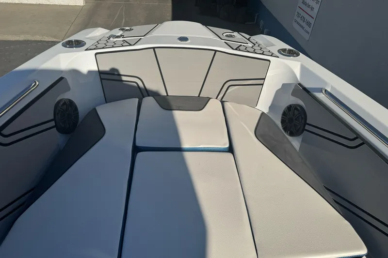 Slide: The Image of 2020 Scarab 255 Open ID boat interior with cushioned seating and speakers. - 24