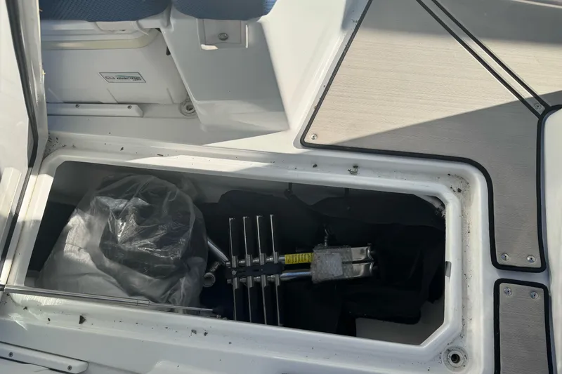 Slide: The Image of Storage compartment of a 2020 Scarab 255 Open ID boat, showing equipment and gear. - 27