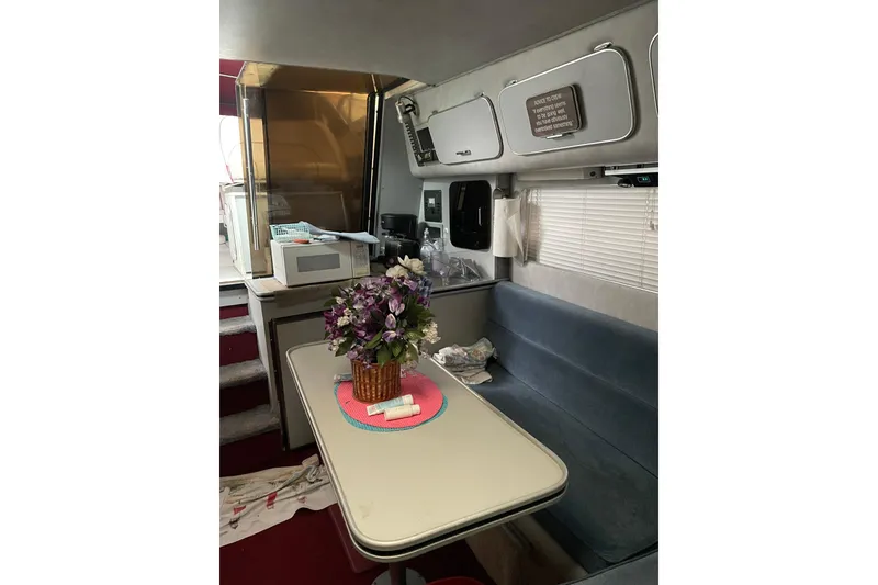 Slide: The Image of Interior of 1987 Chris-Craft 332 Amerosport with dining area and floral centerpiece. - 10