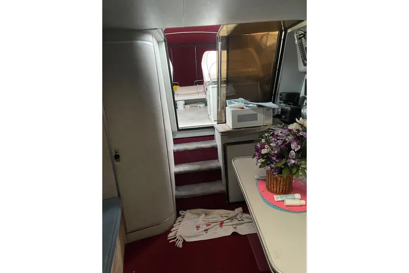 Slide: The Image of Interior of 1987 Chris-Craft 332 Amerosport with kitchen and floral decor. - 11