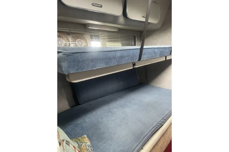 Slide: The Image of Interior cabin of 1987 Chris-Craft 332 Amerosport with blue upholstery and storage compartments. - 14